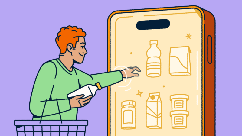 A person holding a shopping basket and selecting consumer packaged goods from a mobile "fridge."