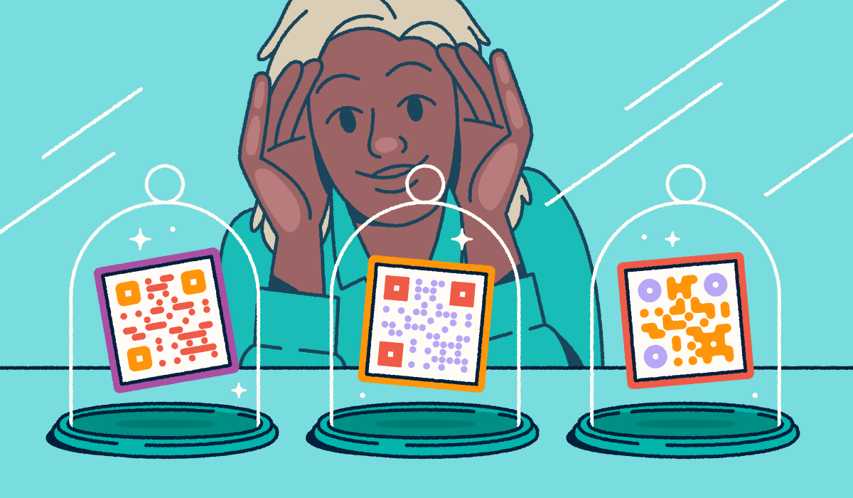 A person looking through a store-front window at three different QR codes on display in glass cloches.